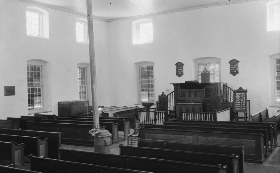 Black-and-white photo from 1934 of the church interior looking north, toward the pulpit.